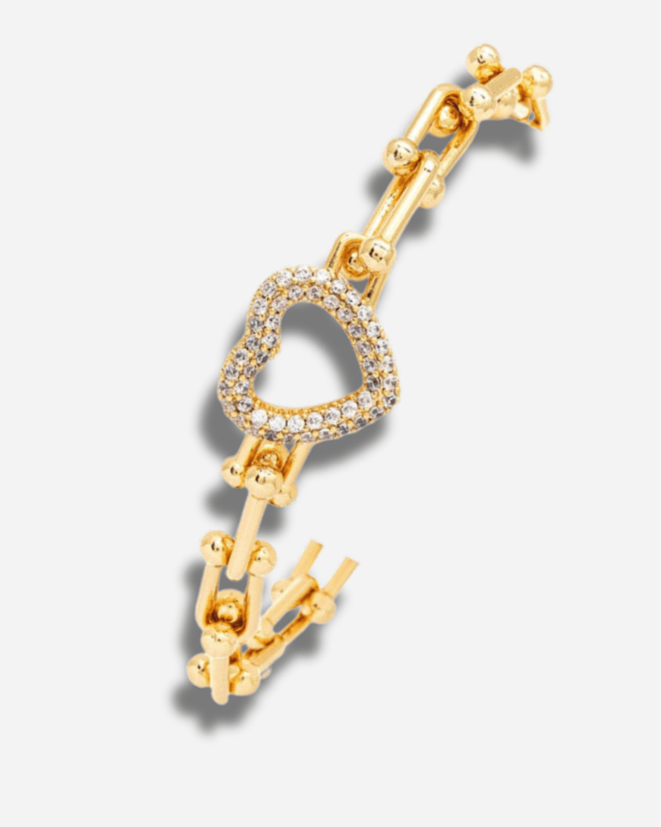 Gold bracelet with heart design and clear stones on a white background