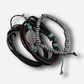 Set of leather and beaded bracelets on a light gray background