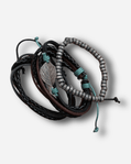 Set of leather and beaded bracelets on a light gray background