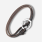 Brown leather bracelet with a silver clasp on a light gray background