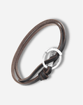 Brown leather bracelet with a silver clasp on a light gray background