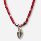 Necklace with red beads and a silver leaf charm on a white background