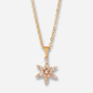 Gold necklace with a star-shaped pendant on a white background