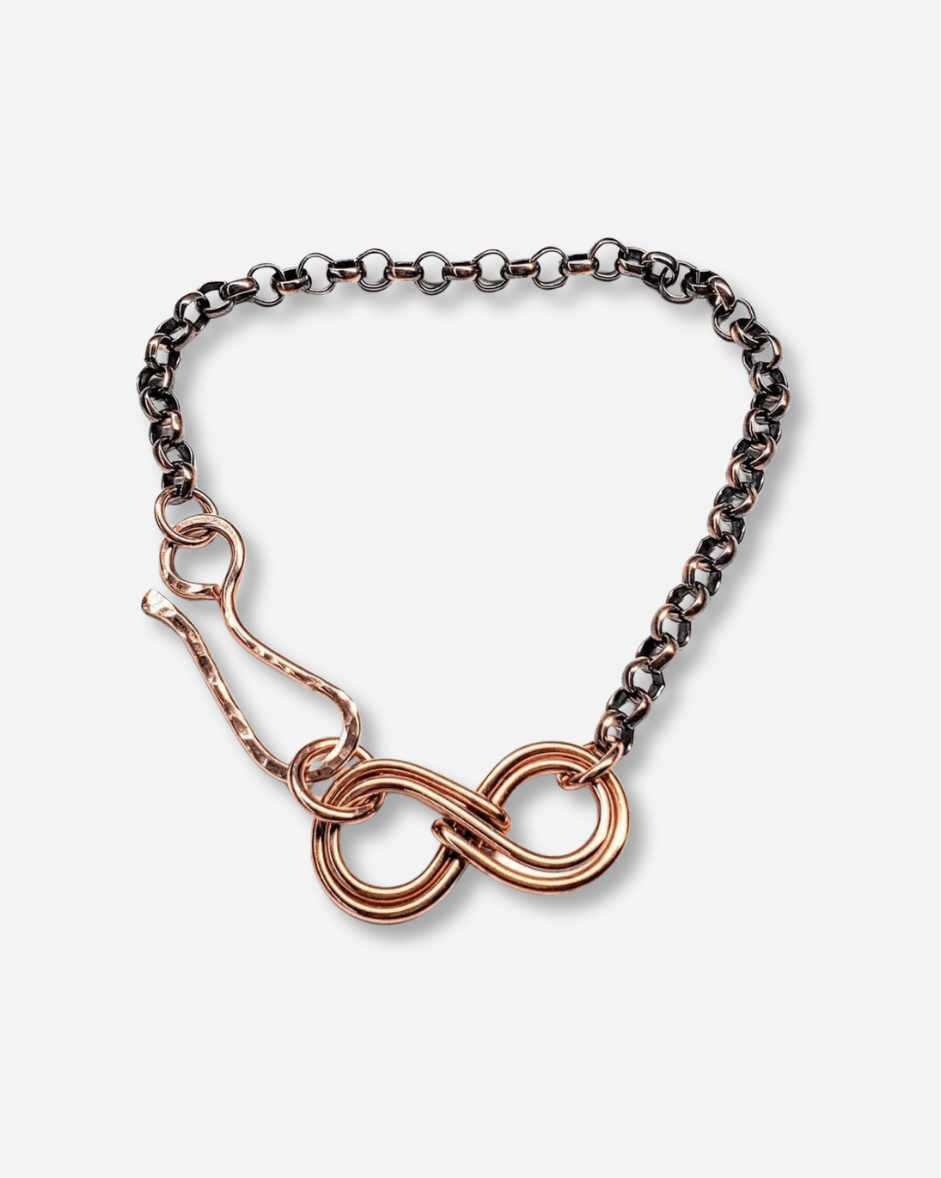 Bracelet with rose gold infinity symbol on a white background