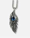 Silver feather-shaped pendant with a blue gemstone on a white background