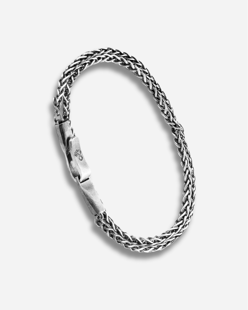 Silver braided bracelet on a white background