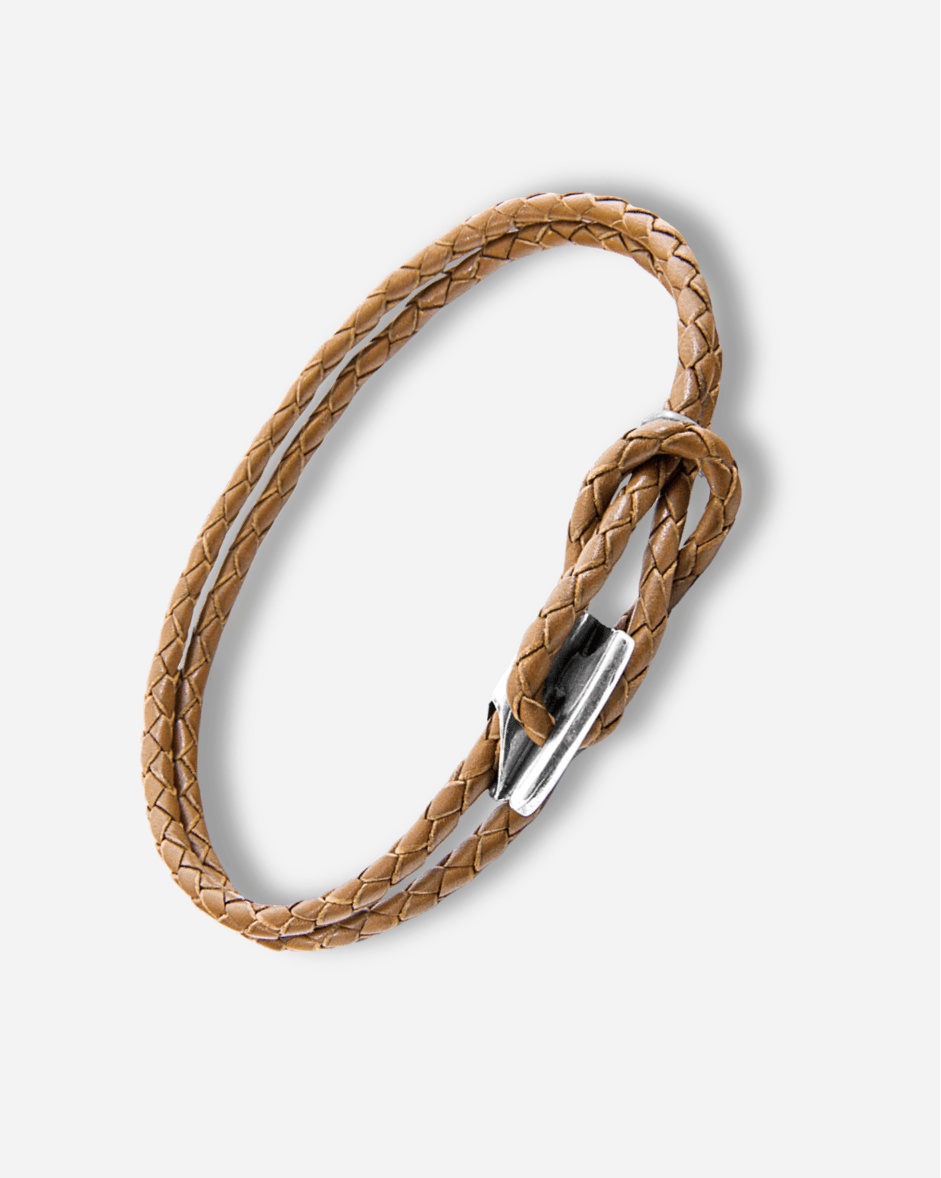 Brown braided leather bracelet with a silver clasp on a white background