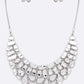 Silver necklace and earrings set on a white background