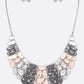 Necklace and earrings set with gray and pink stones on a white background