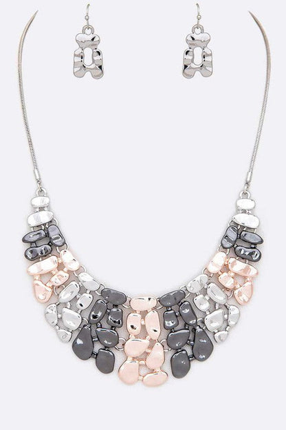 Necklace and earrings set with gray and pink stones on a white background