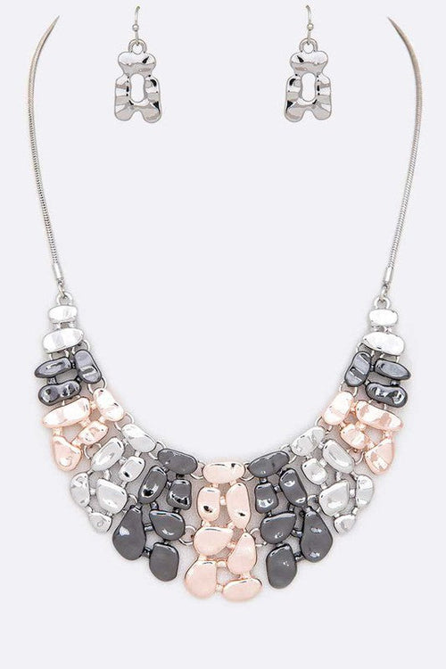 Necklace and earrings set with gray and pink stones on a white background