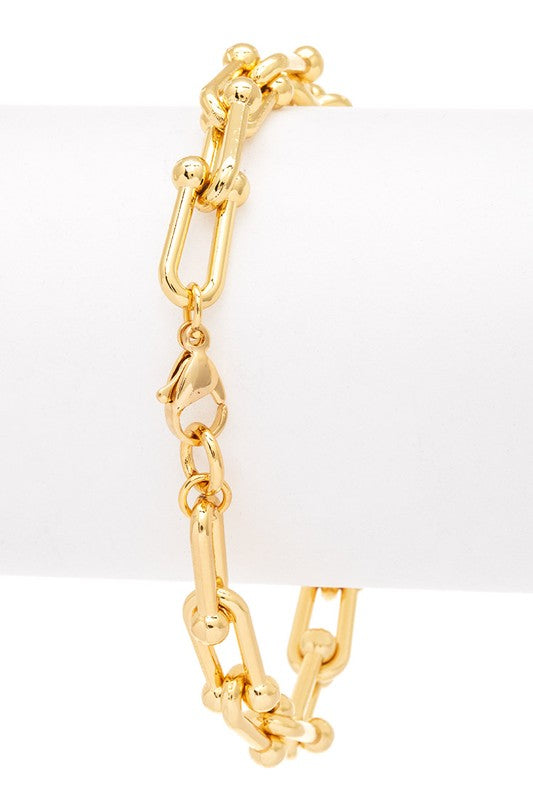 Gold chain bracelet on a white background