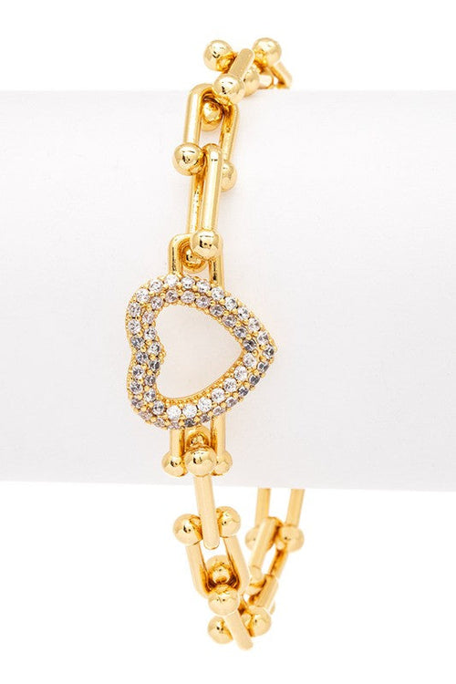 Gold bracelet with a heart-shaped clasp on a white background