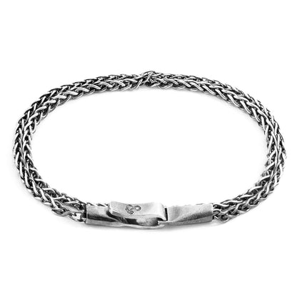 Silver braided bracelet on a white background
