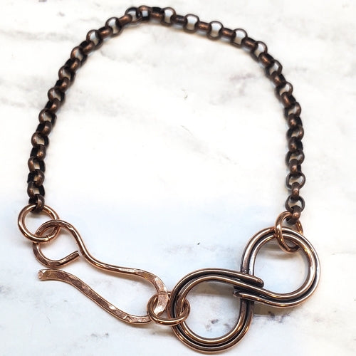 Bronze chain necklace on a marble background