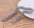 Silver chain bracelet on a textured surface with text