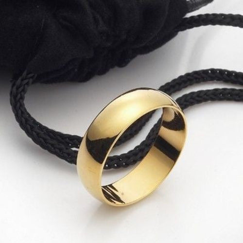 Gold bracelet on a black braided cord against a white background