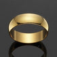 Gold ring on a reflective black surface with a dark background