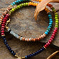 Colorful beaded necklaces on a stone surface