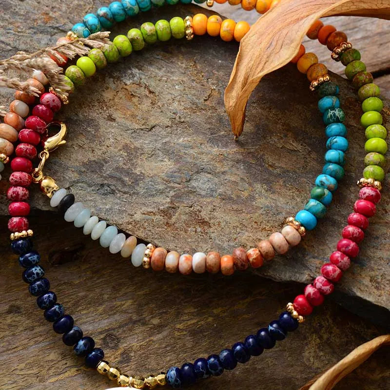 Colorful beaded necklaces on a stone surface