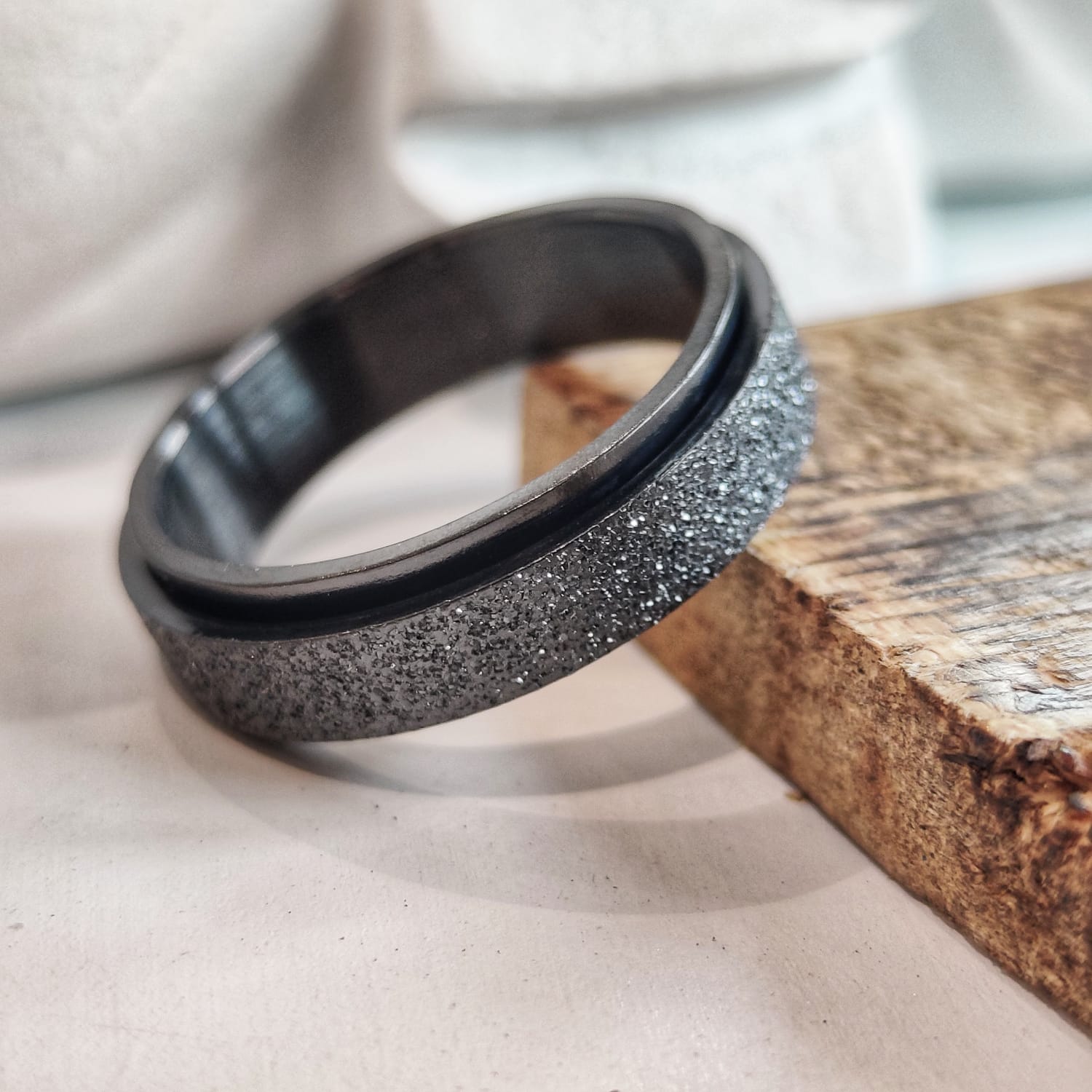 Black and silver ring on a textured surface