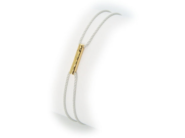 White bracelet with gold clasp on a white background