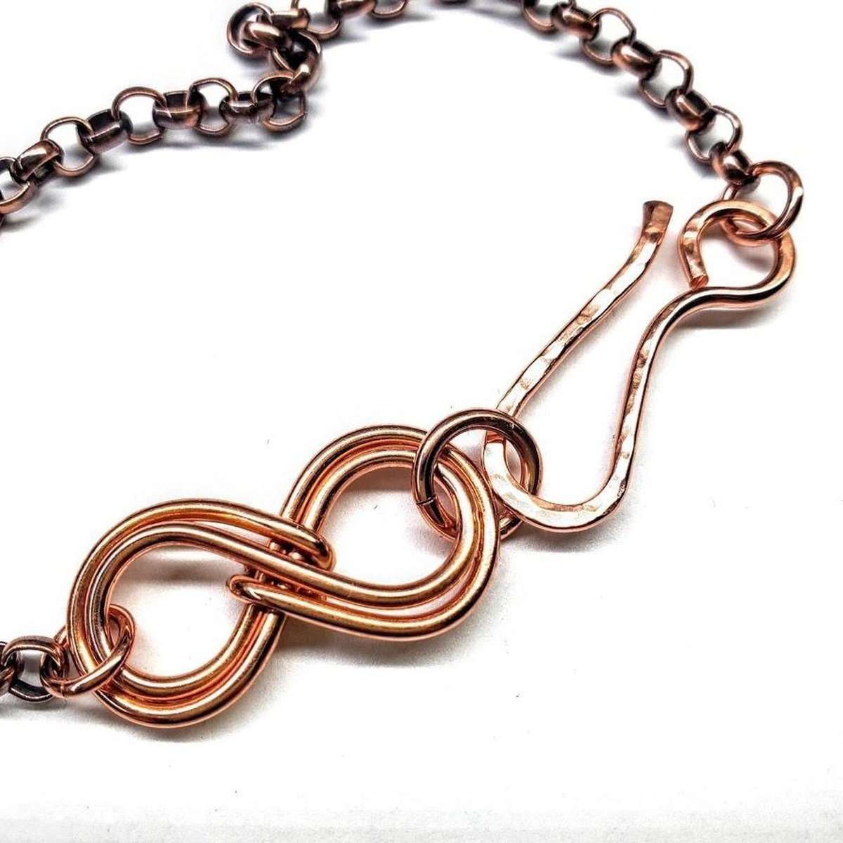 Rose gold chain necklace on a white background