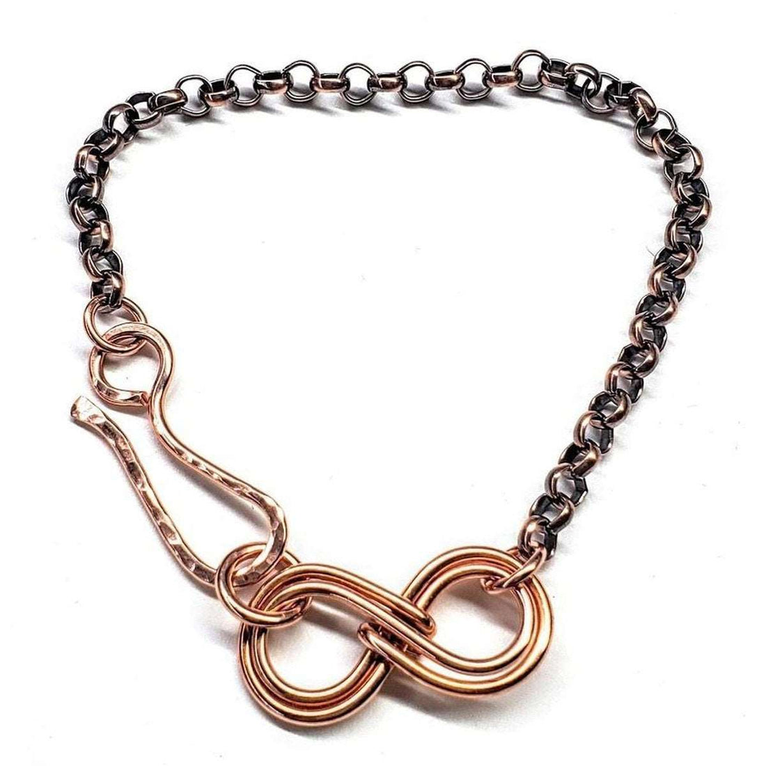 Necklace with interlocking metal rings on a white background
