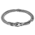 Silver chain bracelet with a clasp on a white background