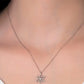 Snowflake pendant necklace on a person wearing a white shirt