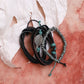 Set of braided bracelets with metal charm on a textured surface