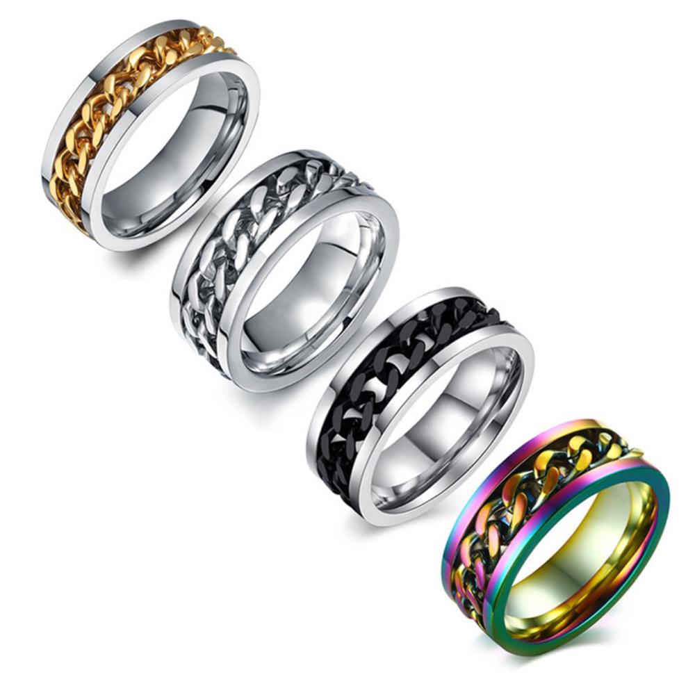 Four metallic rings with chain designs on a white background